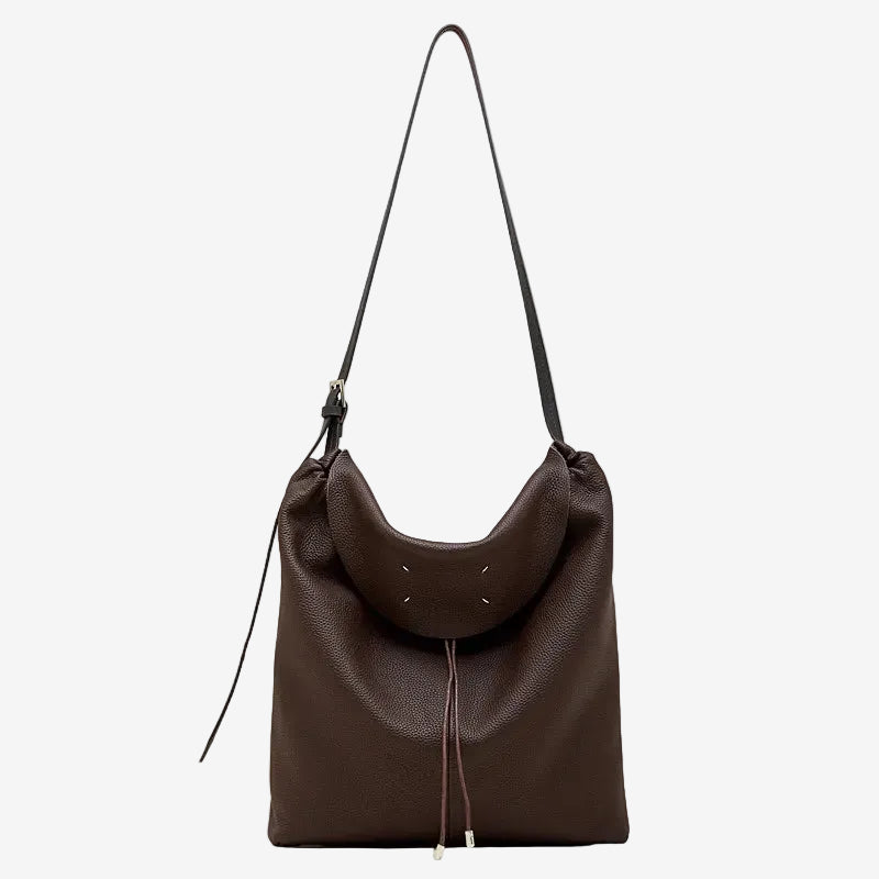 A front view of the Cuirae coffee genuine leather tote bag standing on a plain background.