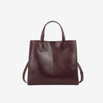 A front view of the Cuirae coffee genuine leather tote bag standing on a plain background.
