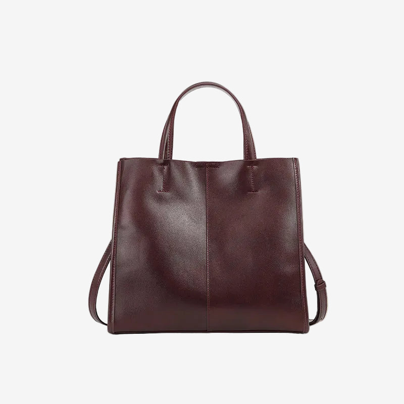 A front view of the Cuirae coffee genuine leather tote bag standing on a plain background.
