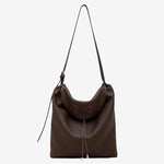 A front view of the Cuirae coffee genuine leather tote bag standing on a plain background.