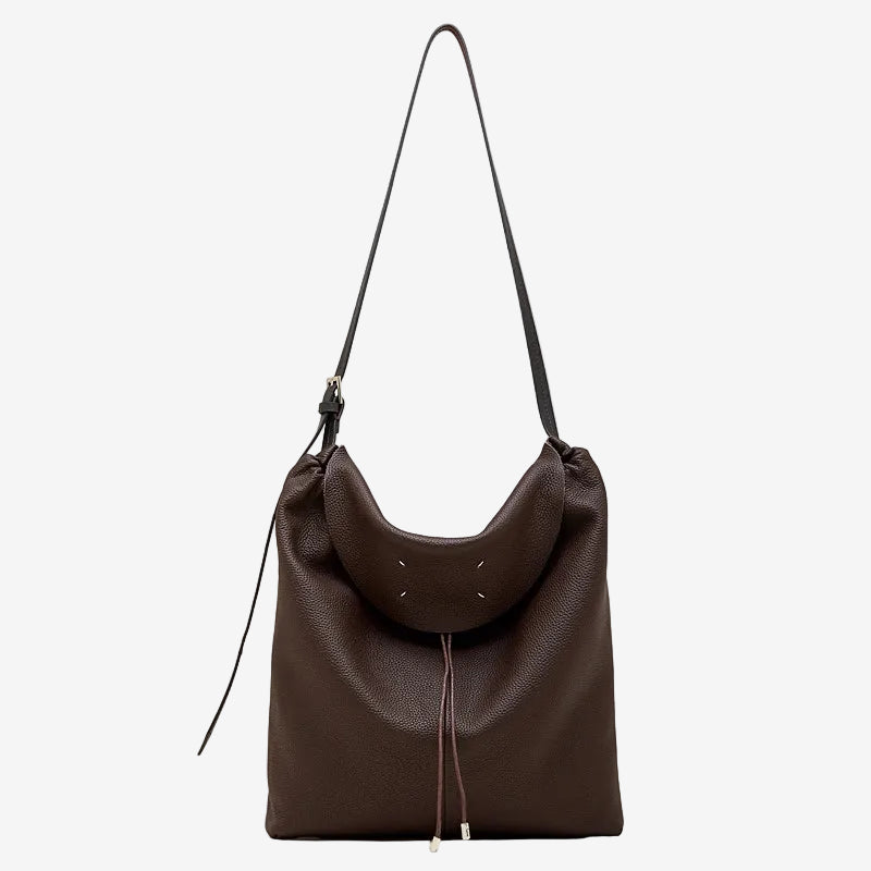 A front view of the Cuirae coffee genuine leather tote bag standing on a plain background.