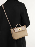 Cuirae gray genuine leather crossbody bag worn crossbody by model, back view showing adjustable strap length