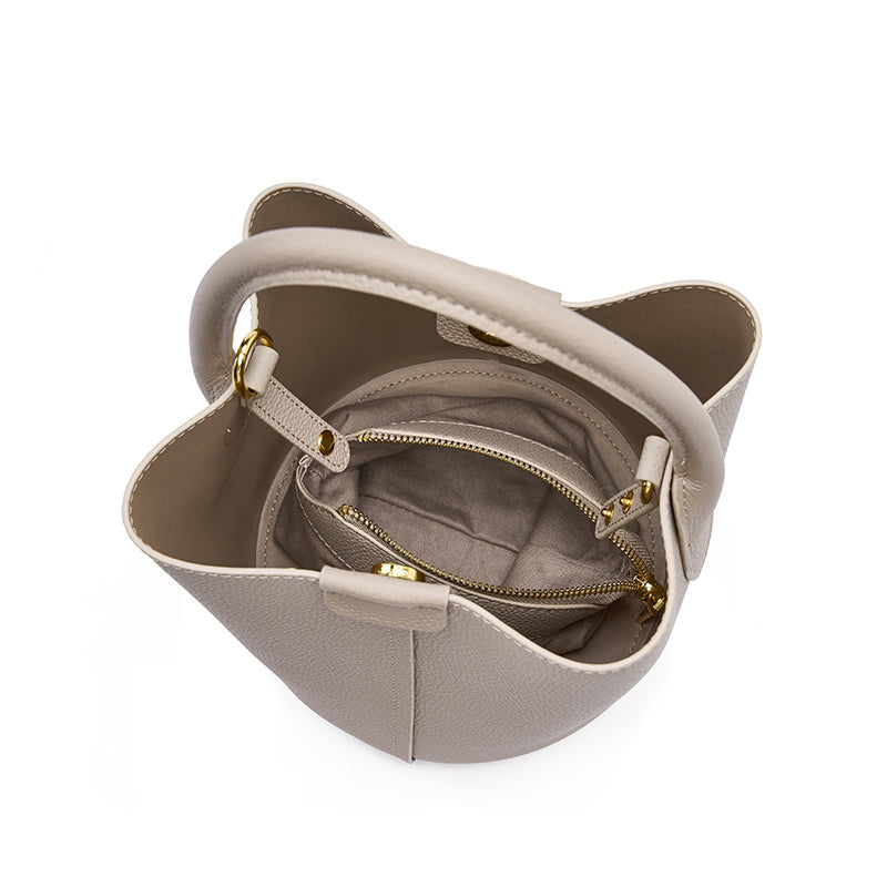 Top-down interior view of Cuirae gray genuine leather bucket bag showing internal zipper pocket, spacious main compartment, and light interior lining