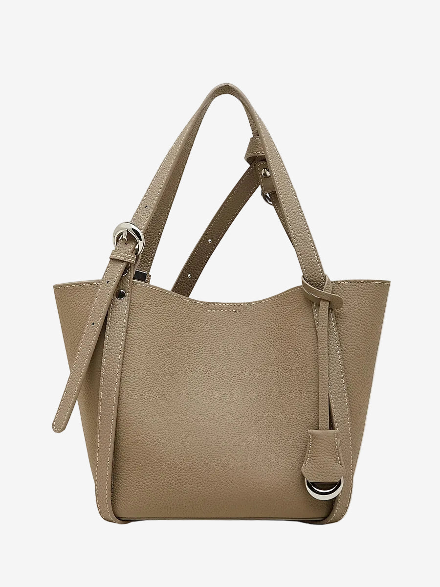 Cuirae gray pebbled genuine leather bucket bag with adjustable strap and silver hardware, front view on white background