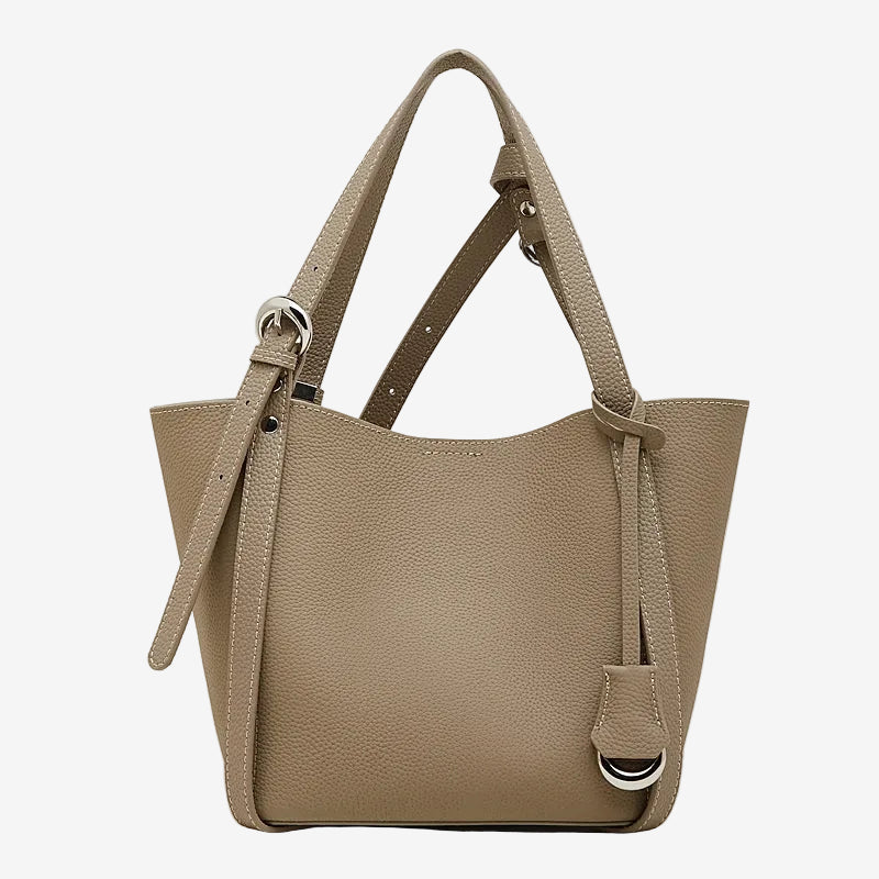Cuirae gray pebbled genuine leather bucket bag with adjustable strap and silver hardware, front view on white background