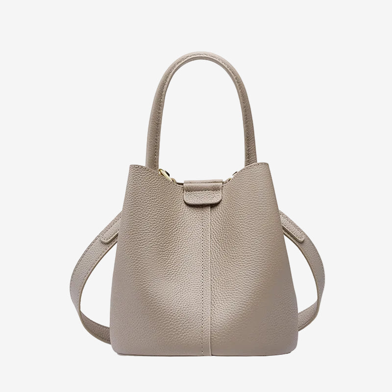 Cuirae gray pebbled genuine leather bucket bag with top handle and detachable strap, front view on white background