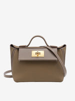 Cuirae gray pebbled genuine leather flap kelly crossbody bag with gold turnlock hardware, front view on white background

