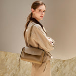 Model wearing the Cuirae gray pebbled leather flap shoulder bag