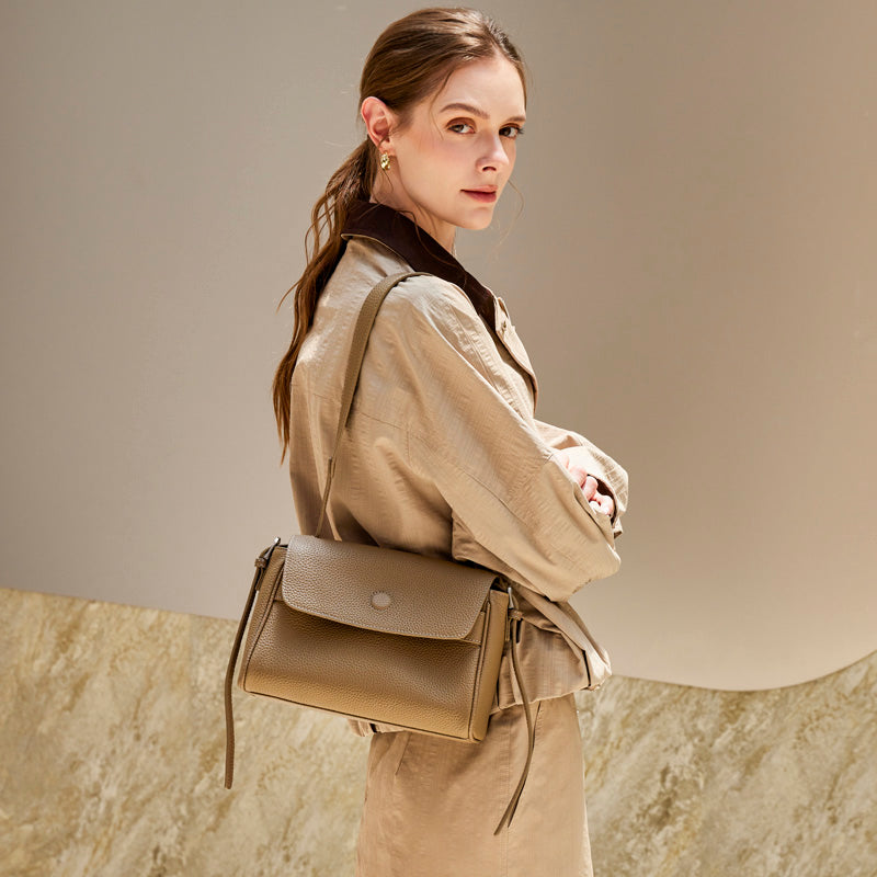 Model wearing the Cuirae gray pebbled leather flap shoulder bag