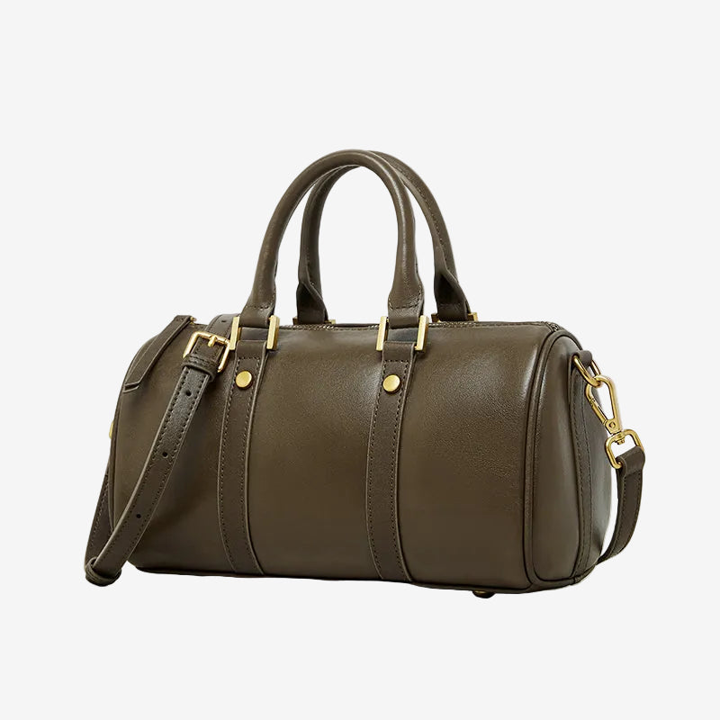 Cuirae green genuine leather barrel crossbody bag with gold hardware and detachable strap, side view on white background