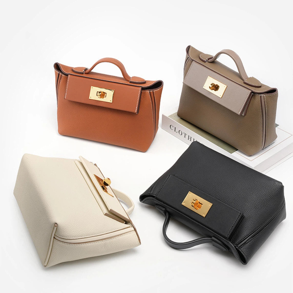 Four Cuirae top grain cowhide crossbody bags in orange, taupe, cream, and black with gold clasps arranged on a white background.