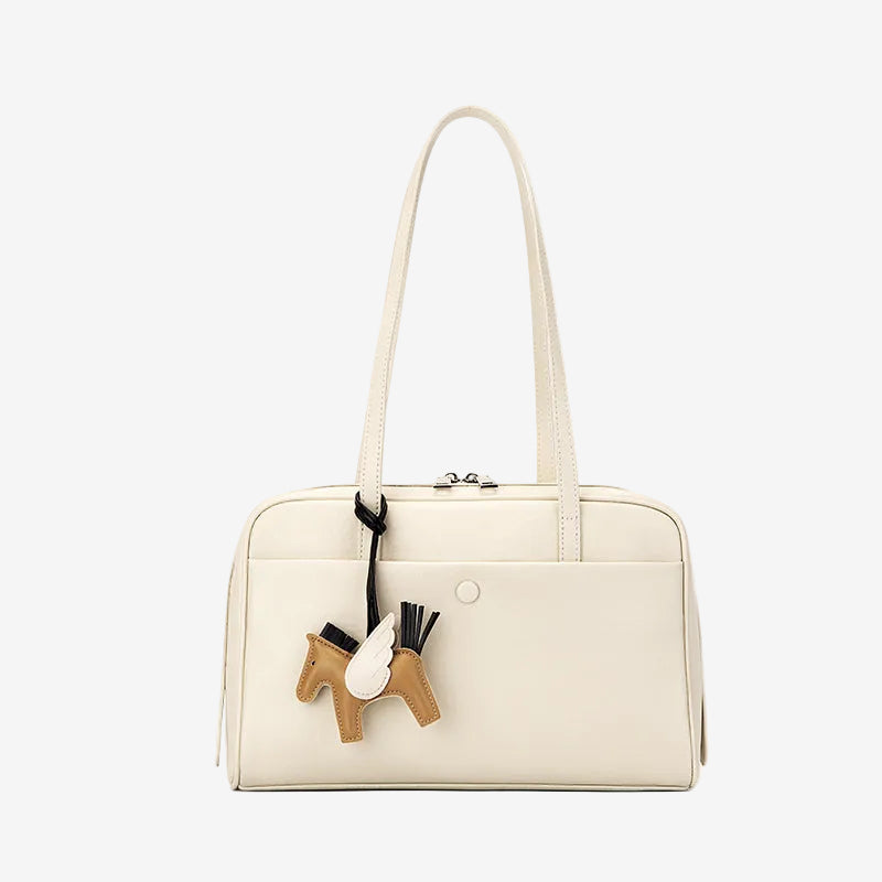 Cuirae off white genuine leather shoulder bowling bag with horse charm and zipper closure, front view plain white background