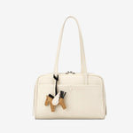 Cuirae off white genuine leather shoulder bowling bag with horse charm and zipper closure, front view plain white background
