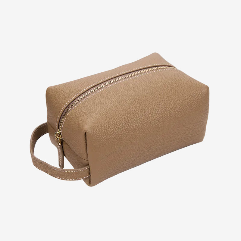 Cuirae stone pebbled genuine leather makeup bag with gold zipper and wrist strap, front angled view on white background