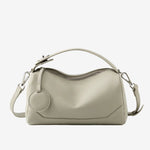 Cuirae stone pebbled genuine leather bowling handbag with round charm and silver hardware, front view on white background