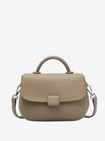 A front view of the Cuirae taupe genuine leather shoulder bag standing on a plain background