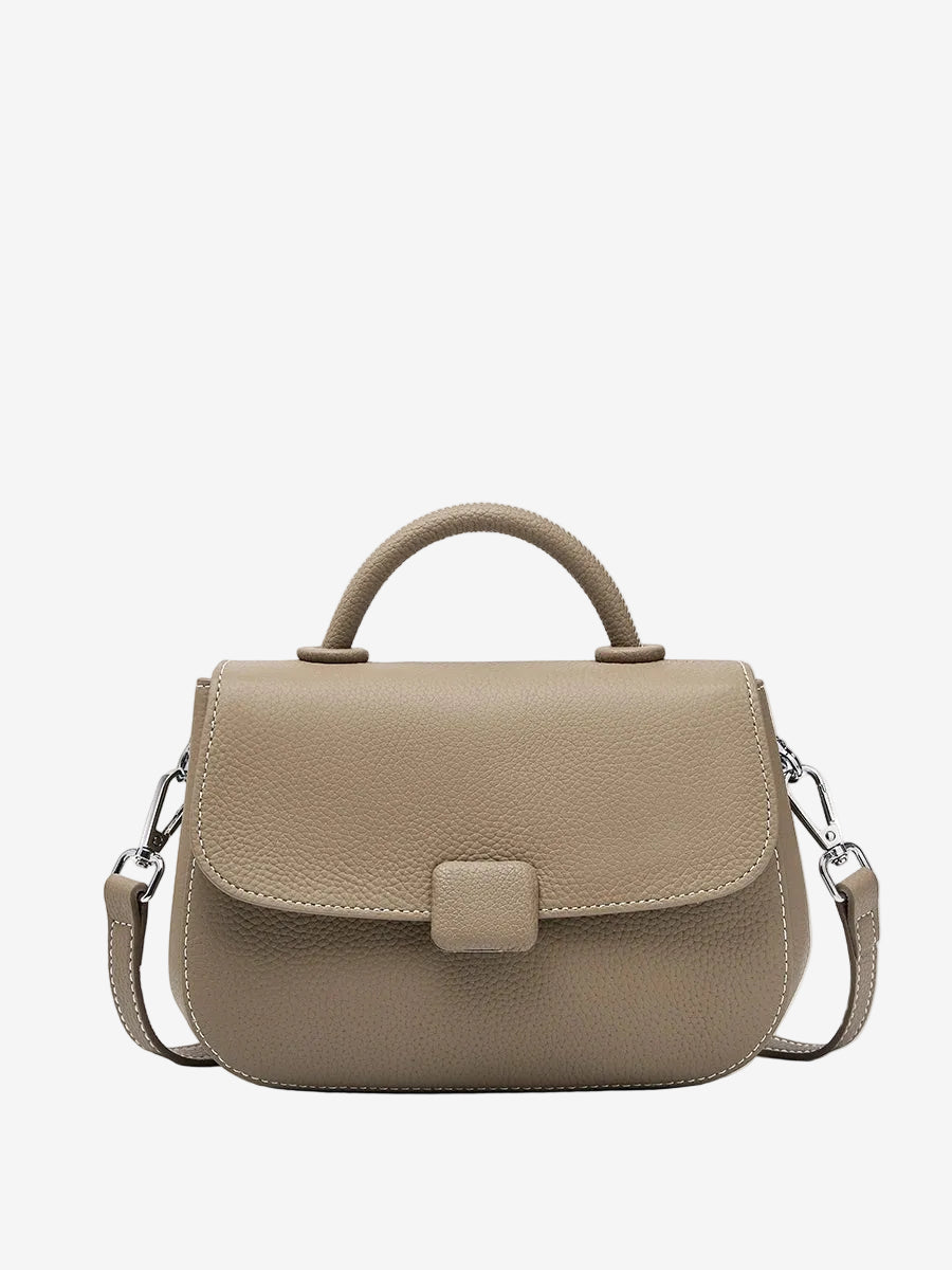 A front view of the Cuirae taupe genuine leather shoulder bag standing on a plain background