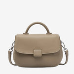 A front view of the Cuirae taupe genuine leather shoulder bag standing on a plain background