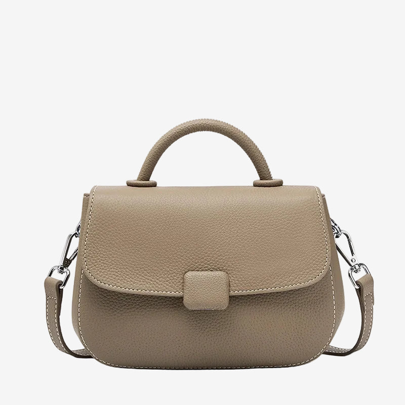 A front view of the Cuirae taupe genuine leather shoulder bag standing on a plain background