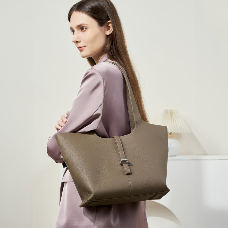 A model wearing the Cuirae taupe genuine leather tote bag on her shoulder.