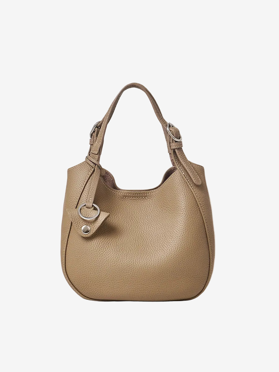 Cuirae taupe pebbled genuine leather bucket bag with silver hardware and top handle, front view on white background