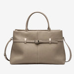 Cuirae taupe pebbled genuine leather handbag with belt buckle detail and silver hardware, front view on white background
