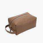 Cuirae taupe pebbled genuine leather makeup bag with gold zipper and wrist strap, front angled view on white background