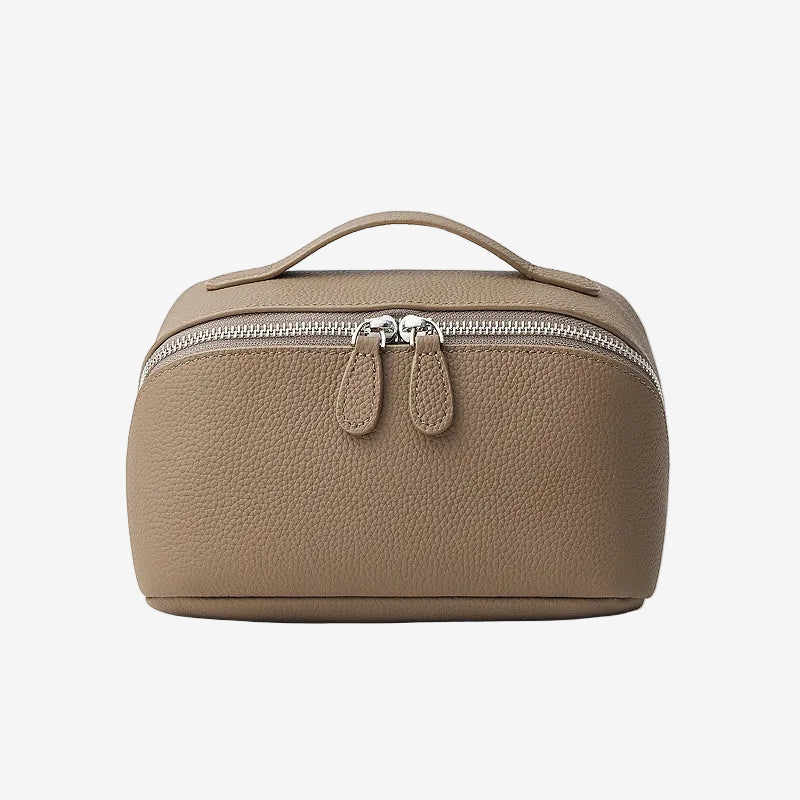 Cuirae taupe pebbled genuine leather makeup bag with top handle and double zipper, front view on white background.