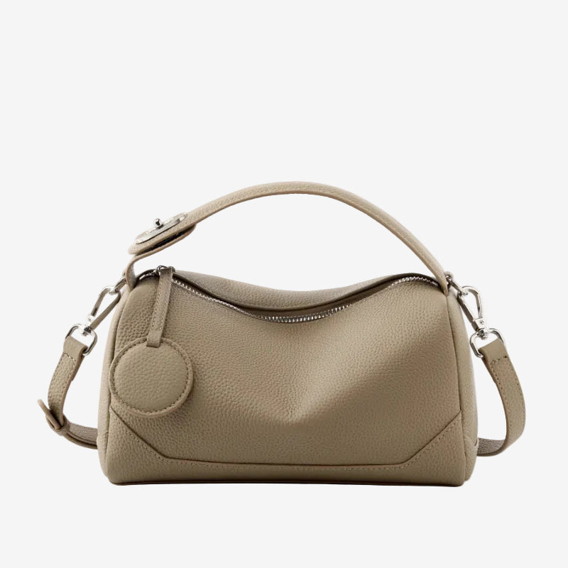 Cuirae taupe pebbled genuine leather bowling handbag with round charm and silver hardware, front view on white background