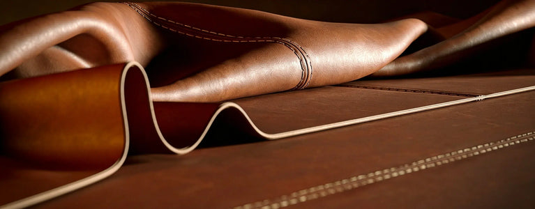 Close up of Cuirae folded brown real leather showing fine stitching. 100% real leather that is built to last.