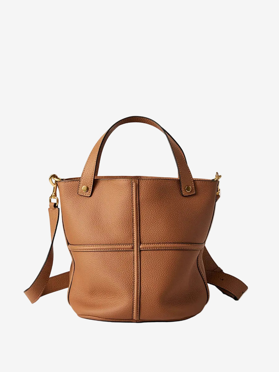 Brown top-grain leather bucket bag with raised cross seams, twin handles, and a detachable shoulder strap