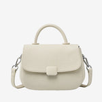 A front view of the Cuirae white genuine leather shoulder bag standing on a plain background