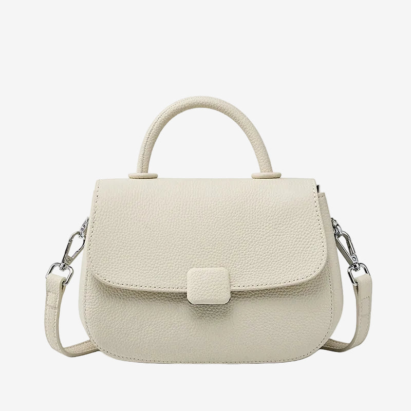 A front view of the Cuirae white genuine leather shoulder bag standing on a plain background