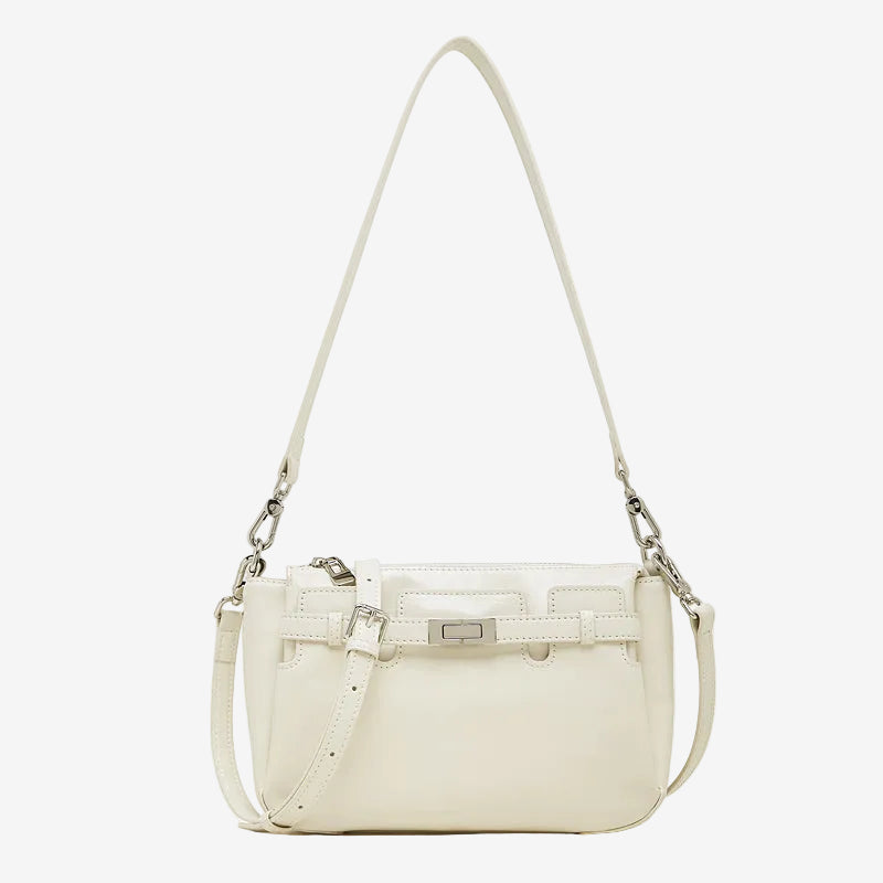 Cuirae white glossy genuine leather crossbody bag with turnlock detail and adjustable strap, front view on white background