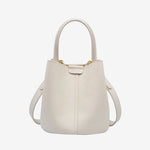 Cuirae white pebbled genuine leather bucket bag with top handle and detachable strap, front view on white background