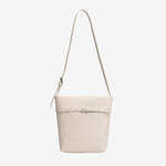 Cuirae white pebbled genuine leather bucket bag with waist belt buckle and silver hardware, front view on white background