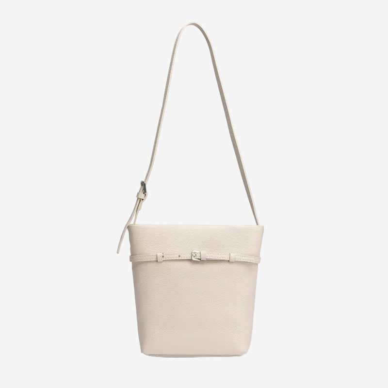 Cuirae white pebbled genuine leather bucket bag with waist belt buckle and silver hardware, front view on white background