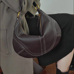 A dynamic showcase of the Cuirae genuine leather shoulder bag, highlighting its spacious interior, built-in pockets, and metal hardware details, as well as how the models demonstrate its versatility with various outfits.