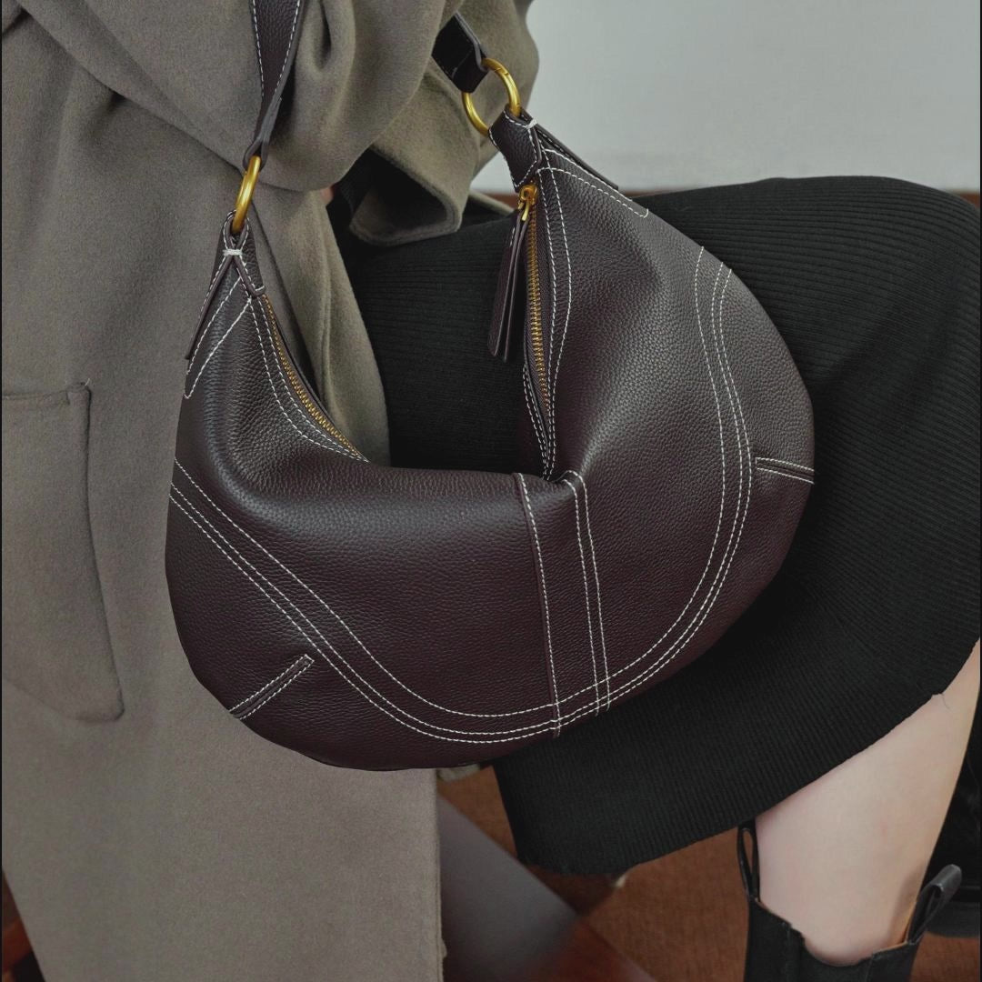 A dynamic showcase of the Cuirae genuine leather shoulder bag, highlighting its spacious interior, built-in pockets, and metal hardware details, as well as how the models demonstrate its versatility with various outfits.
