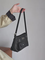 A dynamic showcase of the Cuirae genuine leather crossbody bag, highlighting its spacious interior, built-in pockets, and metal hardware details, as well as how the models demonstrate its versatility with various outfits.