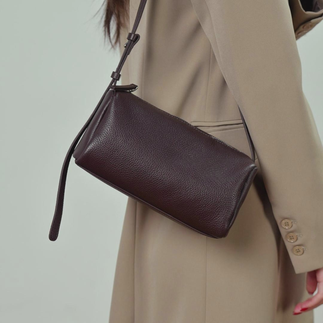 A dynamic showcase of the Cuirae genuine leather crossbody bag, highlighting its spacious interior, built-in pockets, and metal hardware details, as well as how the models demonstrate its versatility with various outfits.