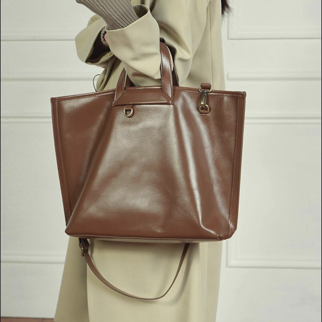 A dynamic showcase of the Cuirae brown genuine leather tote bag, highlighting its appearance up close and the details and metal hardware, as well as how the models demonstrate its versatility with various outfits.