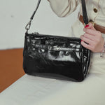 A dynamic showcase of the Cuirae genuine leather crossbody bag, highlighting its appearance up close and the details and capacity, as well as how the models demonstrate its versatility with various outfits.