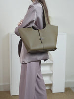 A vibrant display of the Cuirae genuine leather tote bag in various colors showcases how it looks when worn by a model, as well as close-ups of the leather.
