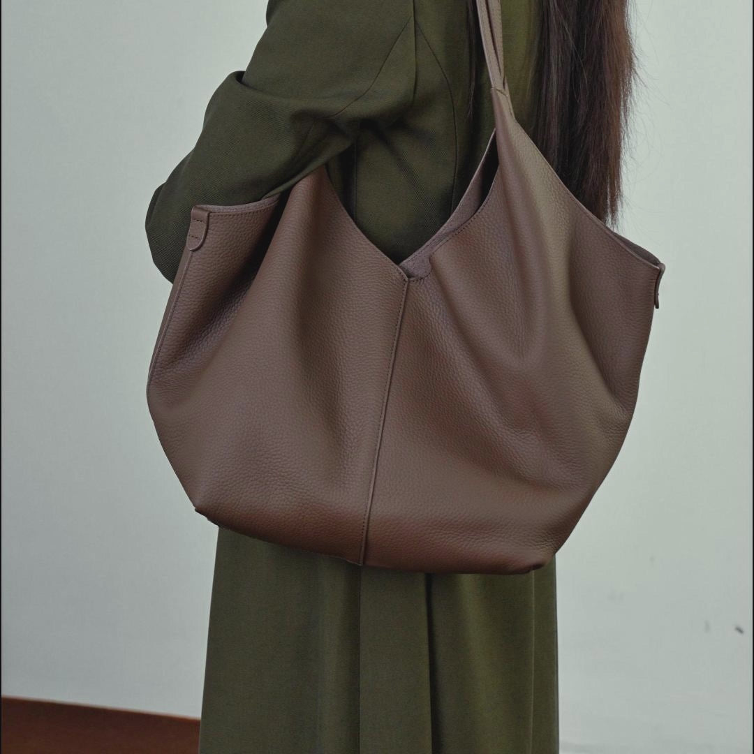 A dynamic showcase of the Cuirae genuine leather tote bag, demonstrating its large capacity, interior pockets, and matching outfit styles.