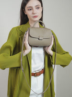 A dynamic showcase of the Cuirae genuine leather shoulder bag, highlighting its appearance up close and the details and metal hardware, as well as how the models demonstrate its versatility with various outfits.