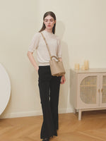 A dynamic showcase of the Cuirae genuine leather crossbody bag, highlighting its appearance up close and the details, as well as how the models demonstrate its versatility with various outfits.