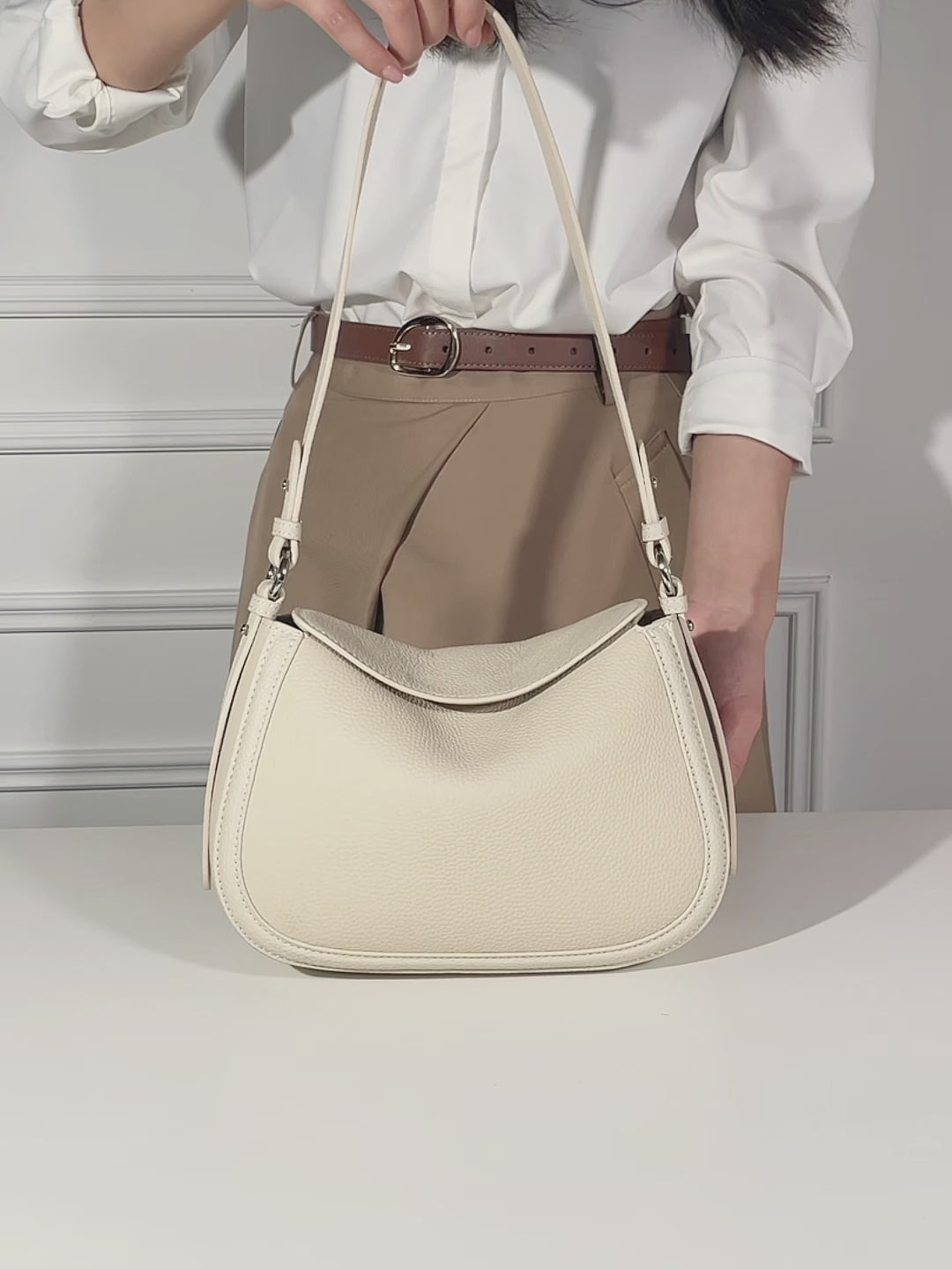 Cuirae pebbled leather shoulder bag video showing its adjustable strap, zippered compartments, and shoulder and crossbody wear.