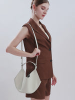 A dynamic showcase of the Cuirae genuine leather crossbody bag, highlighting its appearance up close and the details, as well as how the models demonstrate its versatility with various outfits.