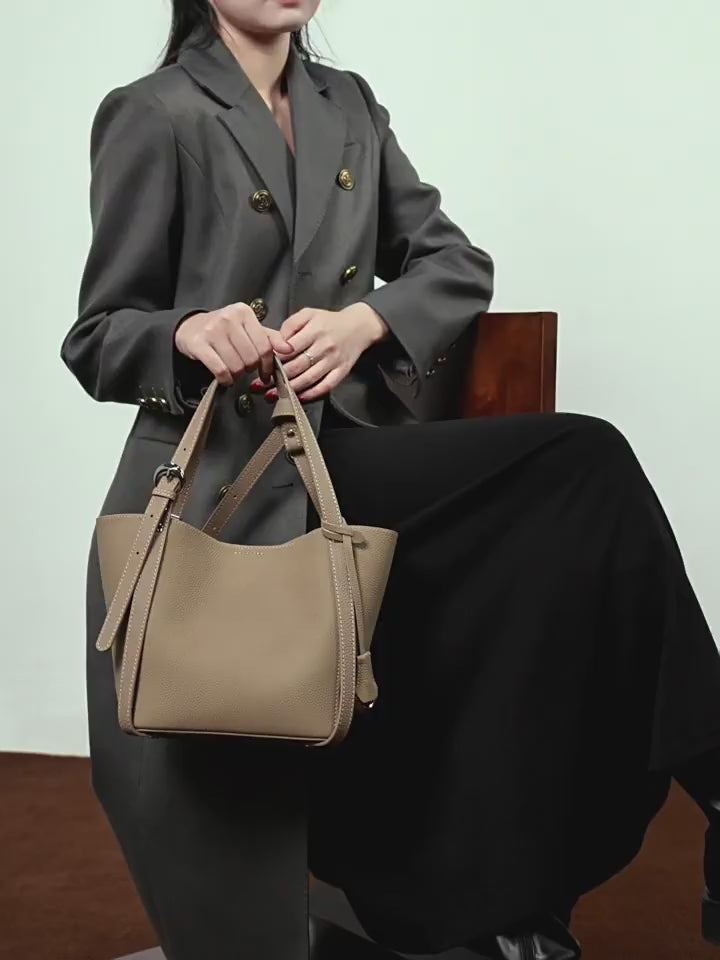 A dynamic showcase of the Cuirae genuine leather bucket bag, highlighting its spacious interior, built-in pockets, and metal hardware details, as well as how the models demonstrate its versatility with various outfits.